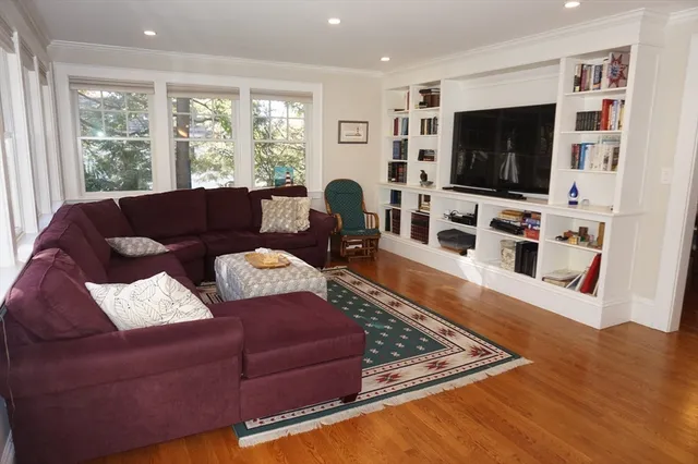a living room with couches and a flat screen tv