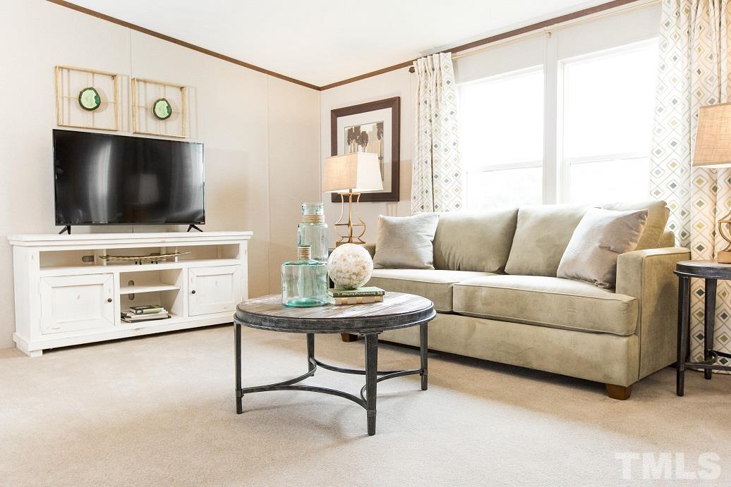 940 Barnes Road Middlesex, NC 27557 - Photo 2 of 11 a living room with furniture and a flat screen tv