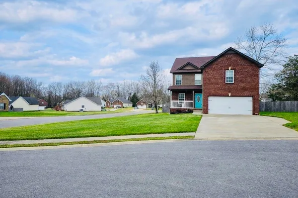 a front view of house with yard and green space