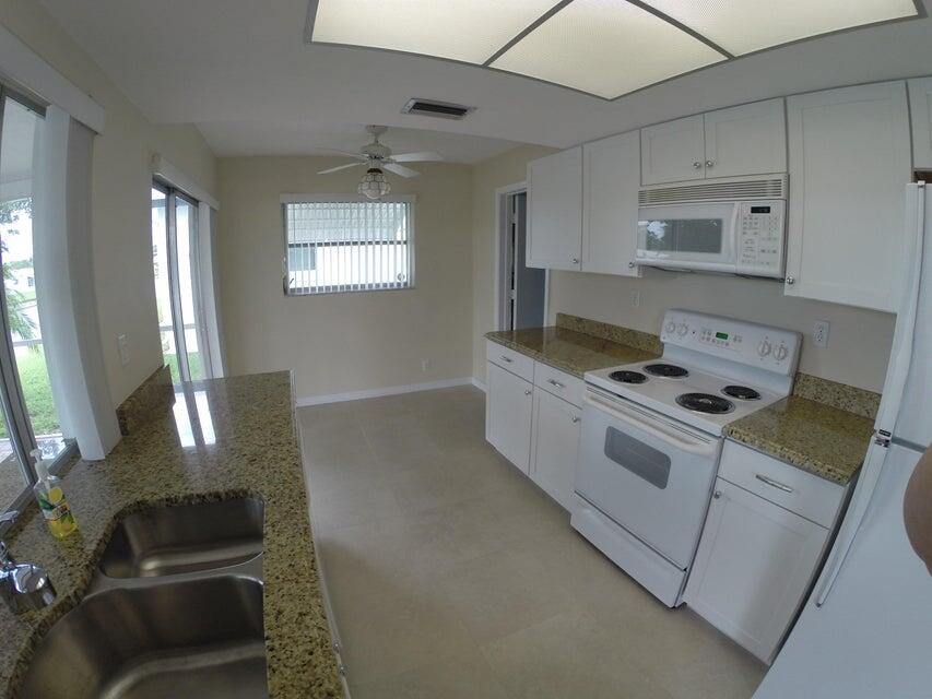 4610 Northwest 47th Street Tamarac, FL 33319 - Photo 4 of 10 a kitchen with granite countertop a stove and a sink