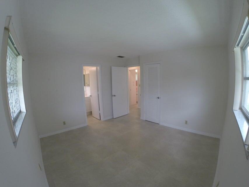 4610 Northwest 47th Street Tamarac, FL 33319 - Photo 5 of 10 an empty room with windows and closet