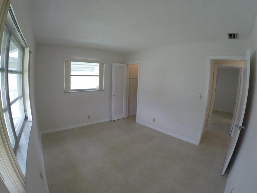 4610 Northwest 47th Street Tamarac, FL 33319 - Photo 6 of 10 an empty room with windows and mirror