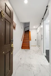 a view of a hallway with wooden walls and stairs