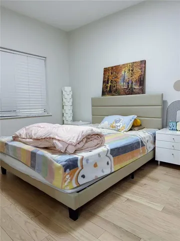 a bedroom with a bed and lamp