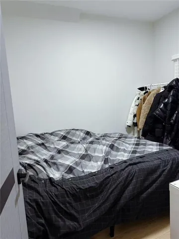 a bed sitting in a bedroom next to a window