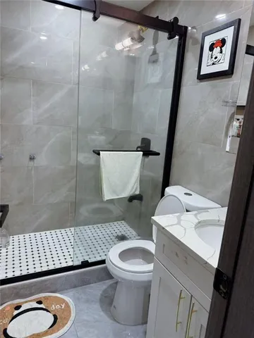 a bathroom with a sink a toilet and a shower