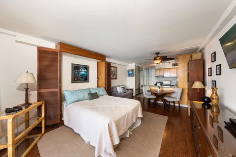 a bedroom with a large bed and a large window