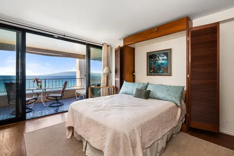 a bedroom with a large bed and a large window