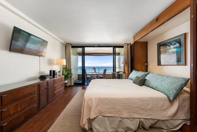 a view of living room kitchen with stainless steel appliances granite countertop furniture and a flat screen tv