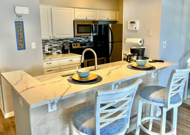 a kitchen with dining table and chairs