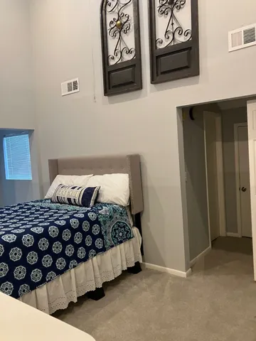 a bedroom with a bed and wall painting