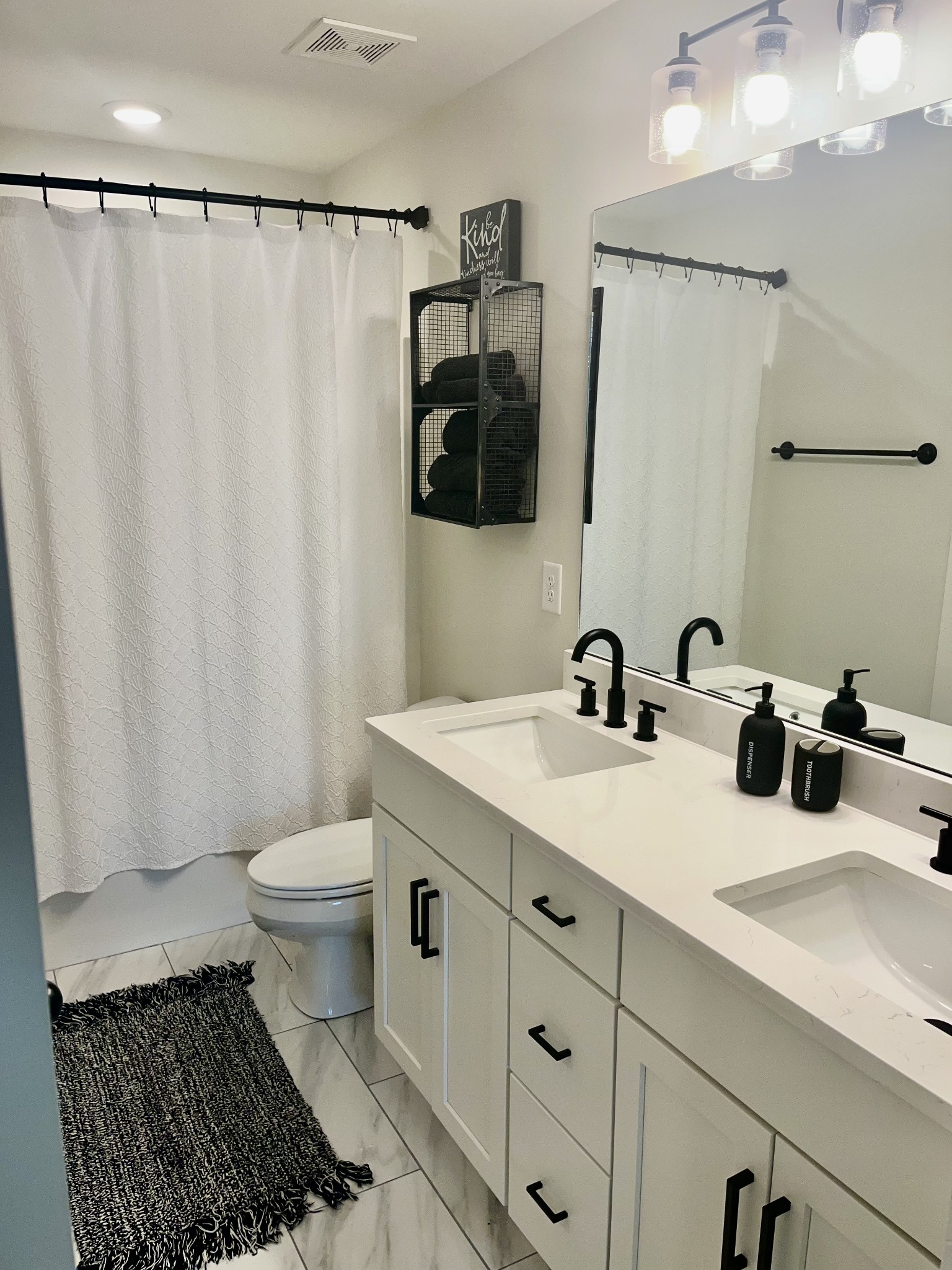 245 Tom Ferrell Road Portland, TN 37148 - Photo 15 of 27 a bathroom with a sink toilet a mirror and shower curtain