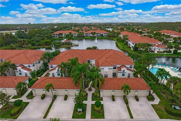 an aerial view of house with yard and lake view