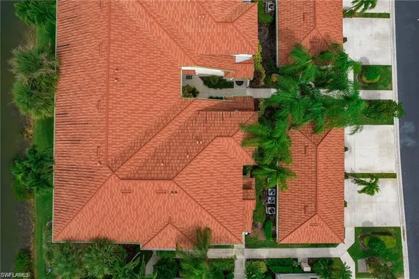 a view of a yard with plants and brick wall