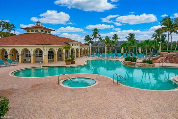 a view of a house with swimming pool and a yard