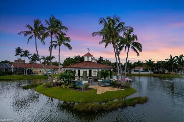 a view of a lake with boats and palm trees