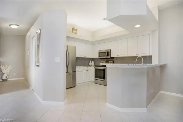 a kitchen with cabinets and stainless steel appliances