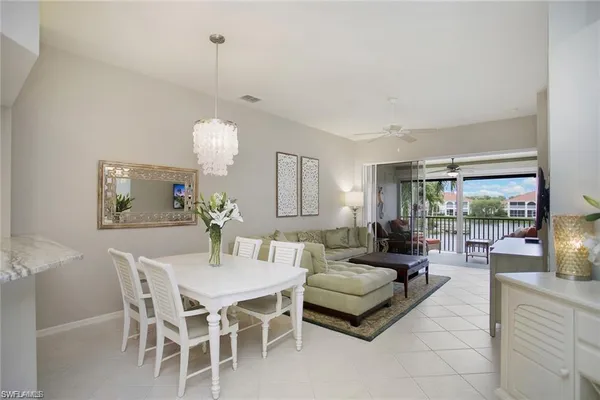 a living room with furniture a lamp and a chandelier