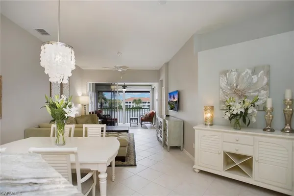 a living room with fireplace furniture and a chandelier