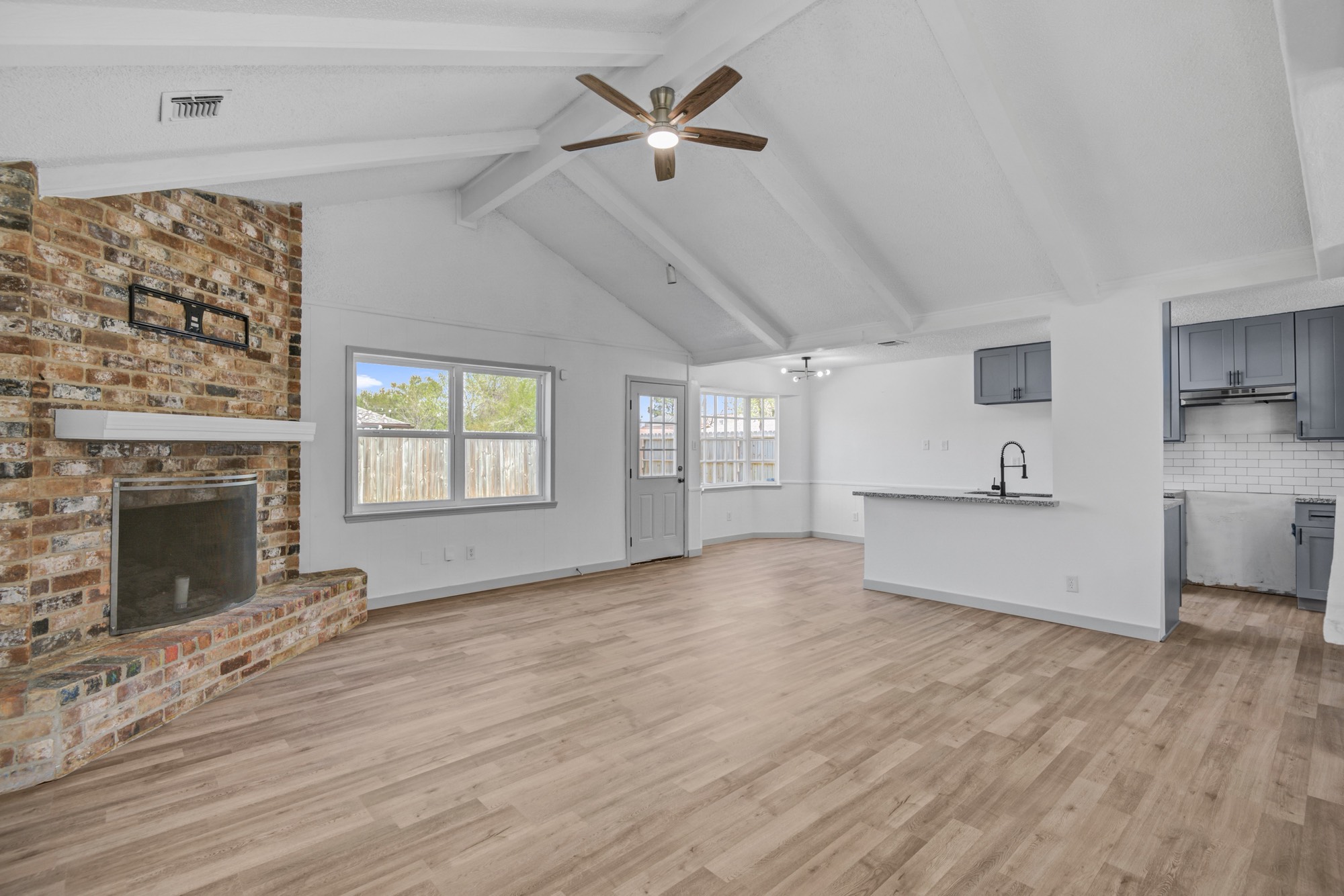 13747 Rampchester Lane Houston, TX 77015 - Photo 9 of 24 a view of an empty room with a fireplace and a window