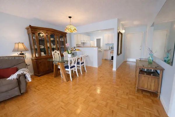 a view of a livingroom with furniture and a kitchen