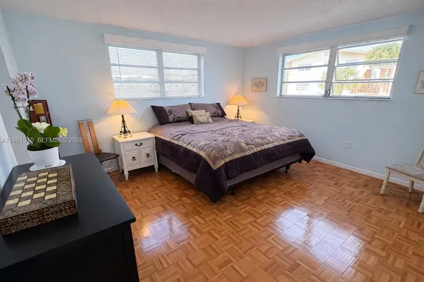 a bedroom with bed and window