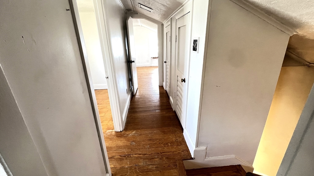 2 Carpenter Road Lynnfield, MA 01940 - Photo 13 of 20 a view of a hallway with wooden floor and stairs