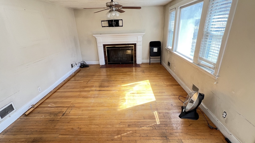 2 Carpenter Road Lynnfield, MA 01940 - Photo 4 of 20 a view of an empty room with furniture and a fireplace