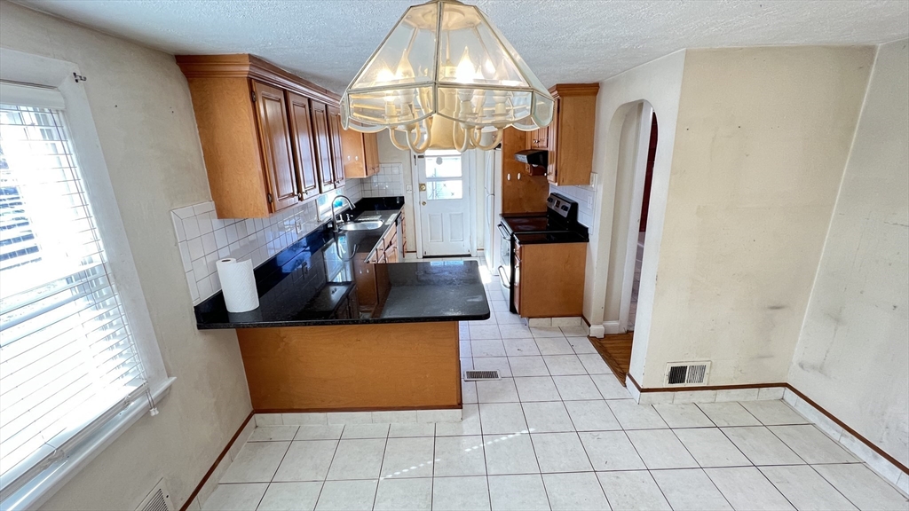 2 Carpenter Road Lynnfield, MA 01940 - Photo 6 of 20 a view of a kitchen with a sink and a refrigerator