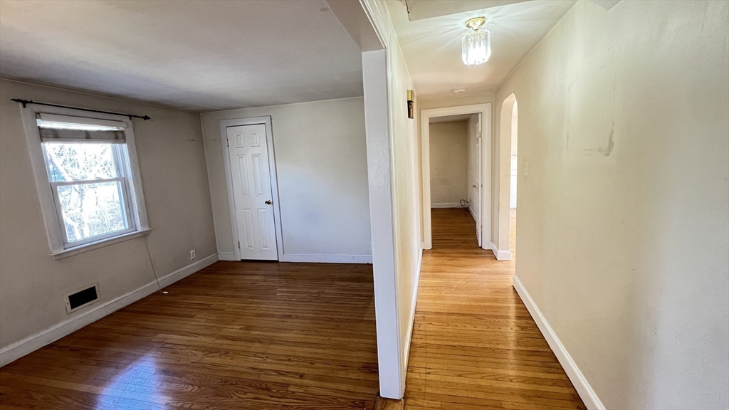 2 Carpenter Road Lynnfield, MA 01940 - Photo 10 of 20 a view of a hallway with wooden floor and staircase