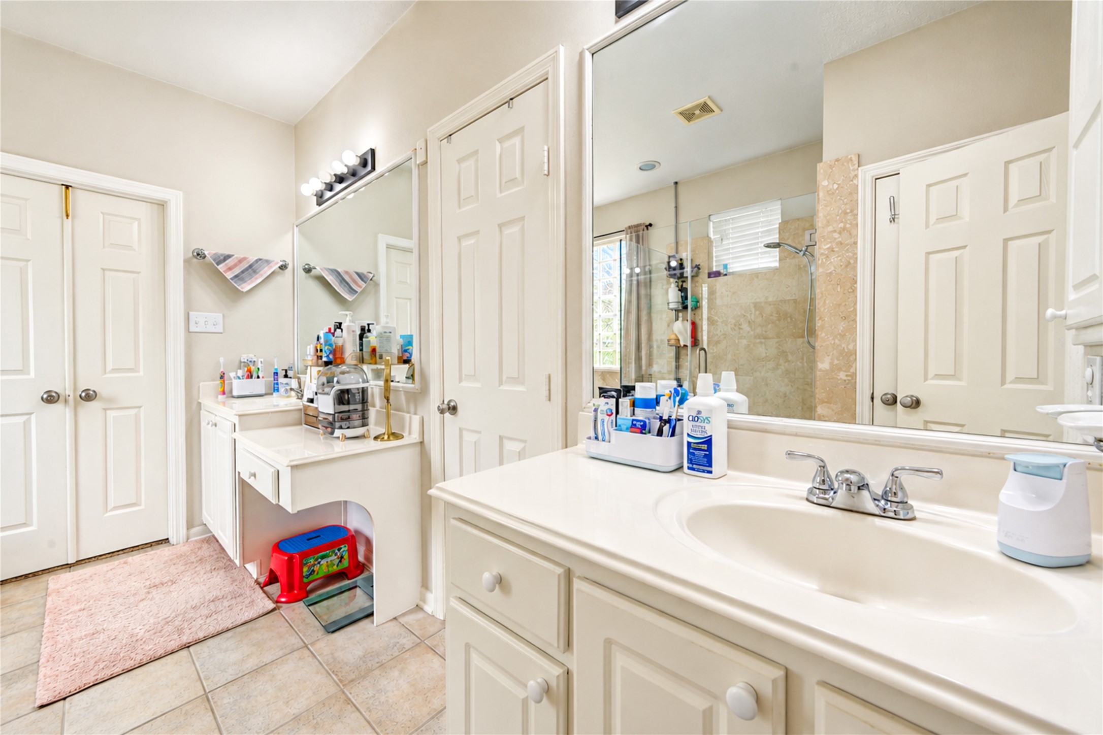 12806 Ridge Bank Lane Houston, TX 77041 - Photo 25 of 44 Bright and spacious bathroom featuring dual sinks, ample counter space, and a large shower with glass doors for a modern touch.