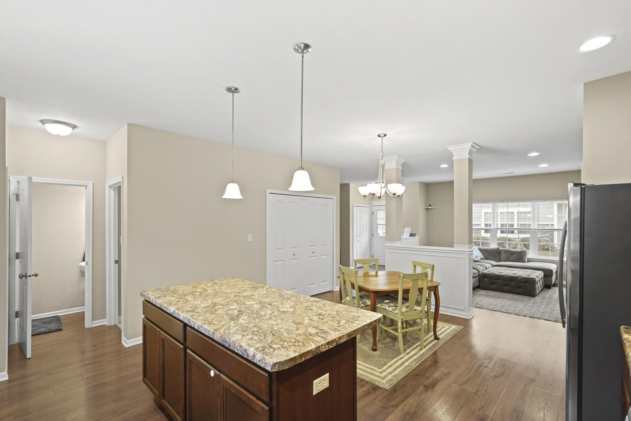 1066 East 115th Court Crown Point, IN 46307 - Photo 8 of 21 a living room with kitchen island a table and chairs