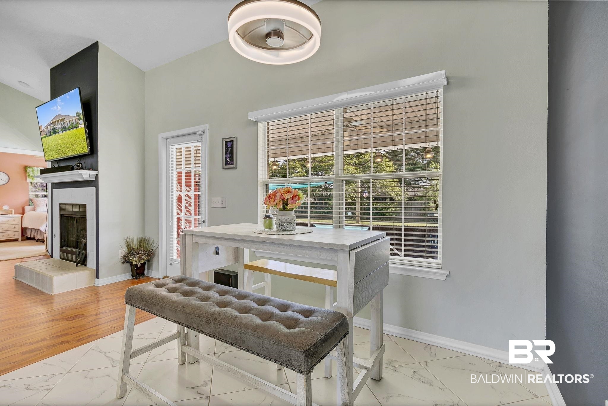 16358 Tempest Drive Foley, AL 36535 - Photo 15 of 46 Dining area featuring a tiled fireplace, marble finish floor, and baseboards