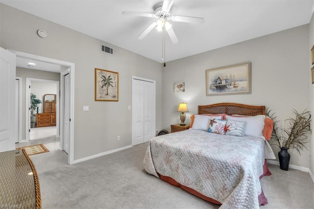 8075 Tiger Cove, Unit 1706 Naples, FL 34113 - Photo 29 of 50 Bedroom featuring carpet floors, a closet, and ceiling fan