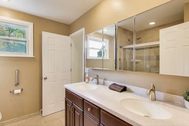 a bathroom with a granite countertop sink mirror and double