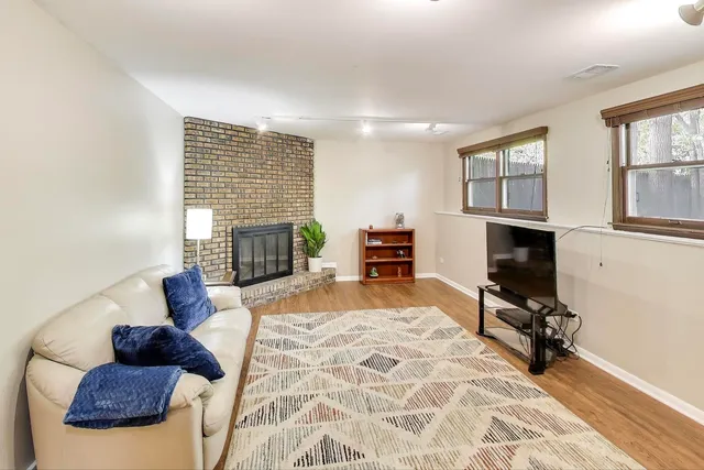 a living room with furniture fireplace and a window