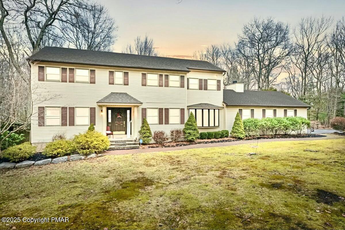 a front view of a house with a garden