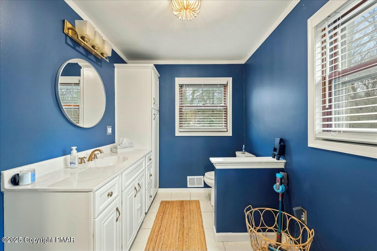 1295 Scotrun Drive Scotrun, PA 18355 - Photo 30 of 76 a bathroom with a sink mirror and a bathtub