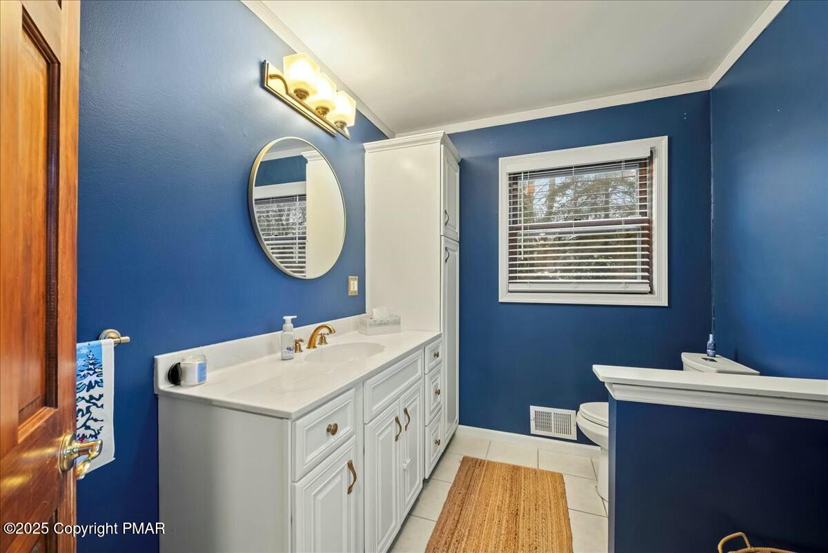 1295 Scotrun Drive Scotrun, PA 18355 - Photo 31 of 76 a bathroom with a sink and a mirror