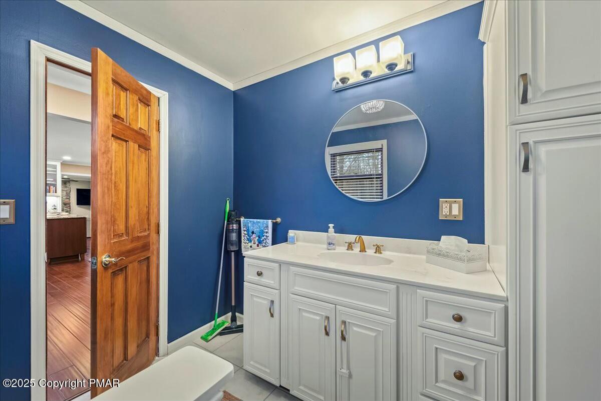 1295 Scotrun Drive Scotrun, PA 18355 - Photo 33 of 76 a bathroom with a toilet a sink a mirror and a window