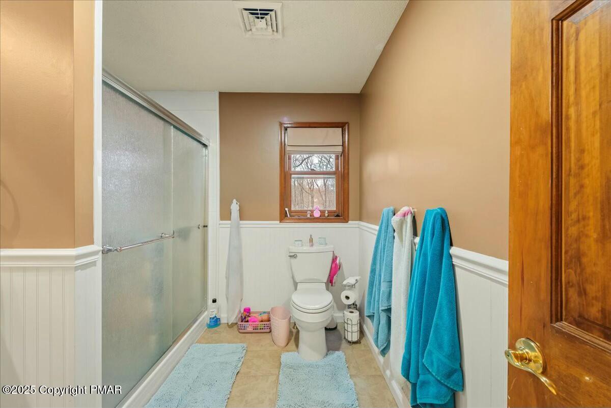 1295 Scotrun Drive Scotrun, PA 18355 - Photo 41 of 76 a bathroom with a toilet and a shower curtain