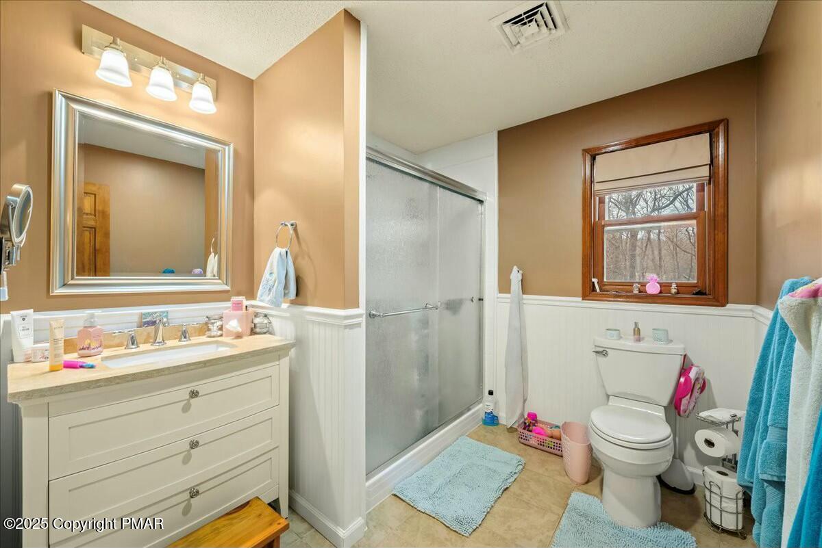 1295 Scotrun Drive Scotrun, PA 18355 - Photo 42 of 76 a bathroom with a sink vanity mirror and toilet