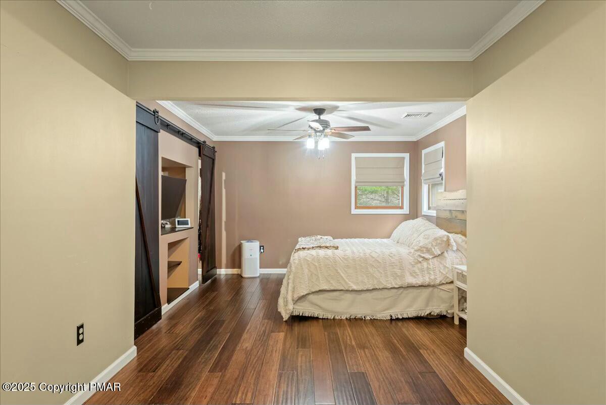 1295 Scotrun Drive Scotrun, PA 18355 - Photo 48 of 76 a bedroom with a bed and wooden floor