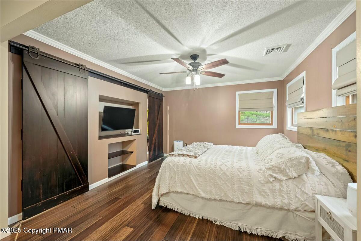 1295 Scotrun Drive Scotrun, PA 18355 - Photo 50 of 76 a bedroom with a large bed and a flat tv screen