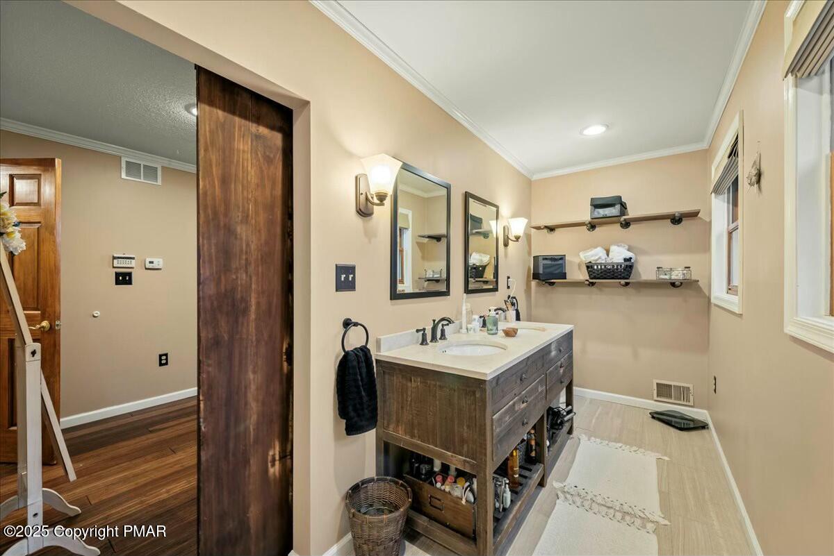 1295 Scotrun Drive Scotrun, PA 18355 - Photo 55 of 76 a en suite bathroom with a sink a mirror and shower