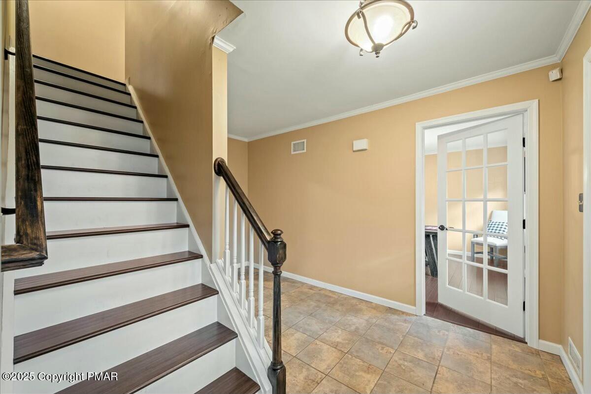1295 Scotrun Drive Scotrun, PA 18355 - Photo 9 of 76 a view of a hallway with wooden floor and staircase