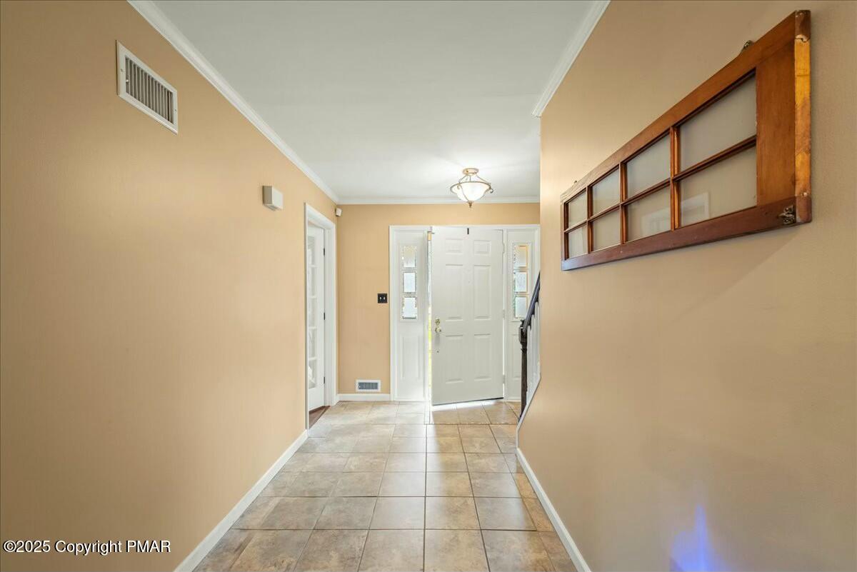 1295 Scotrun Drive Scotrun, PA 18355 - Photo 10 of 76 a view of a hallway with wooden shelves