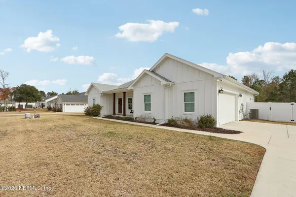 a view of a house with a yard and garage