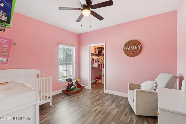 a spacious bedroom with a bed and a chandelier