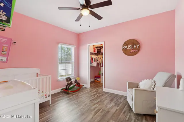 a spacious bedroom with a bed and a chandelier